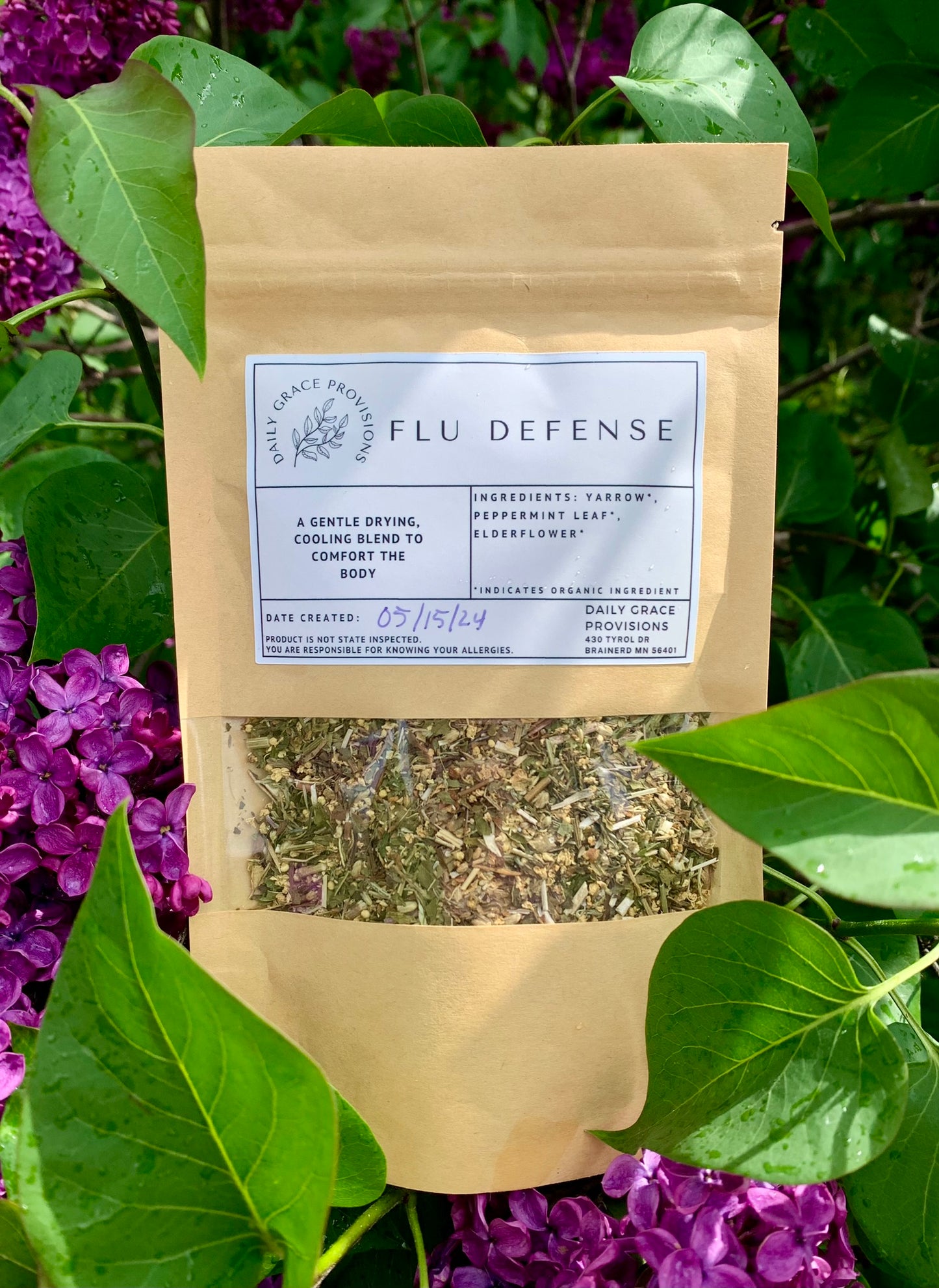 Flu defense tea packaging amongst lilacs